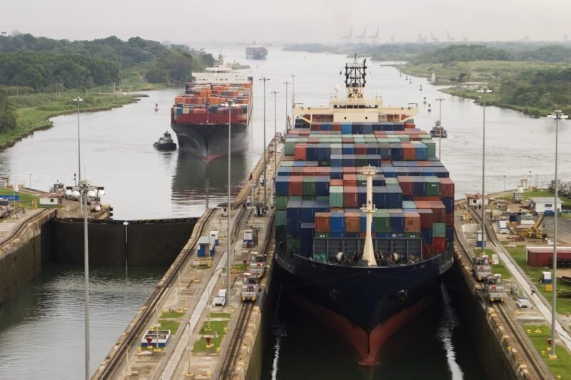 Several freighters, assisted by tugboats, are entering the Panama Canal at Gatun Locks on the Atlantic side.