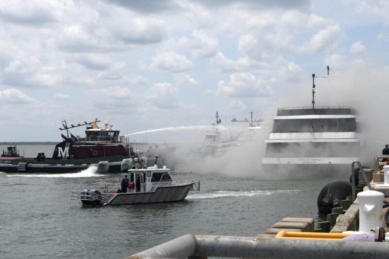 Tugboats spray water on the Spirit of Norfolk passenger vessel after a fire broke out near Naval Station Norfolk in Norfolk, Virginia, June 7, 2022. Credit: U.S. Navy