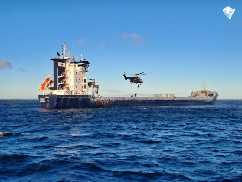 Finnish authorities repel from a helicopter onto the deck of the M/V Fitburg