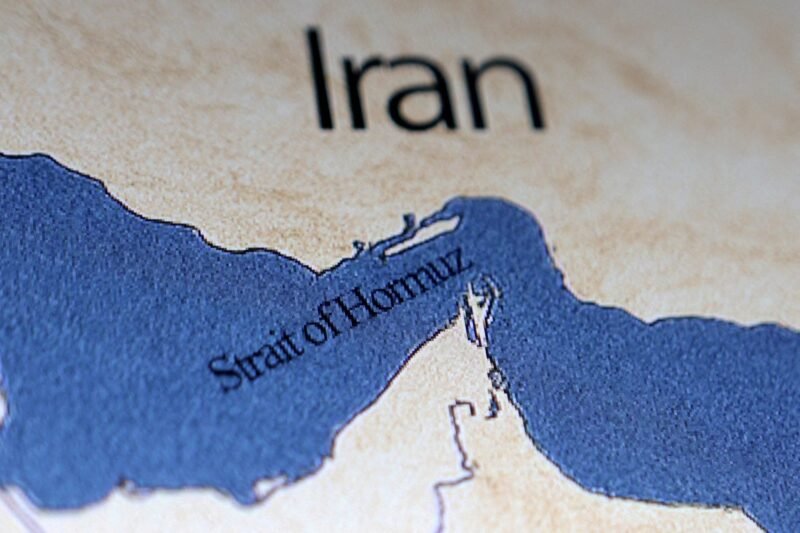 Illustration shows map showing the Strait of Hormuz and Iran