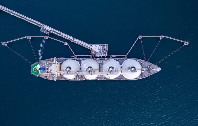 Aerial of Liquified Natural Gas LNG carrier moored to a small gas terminal