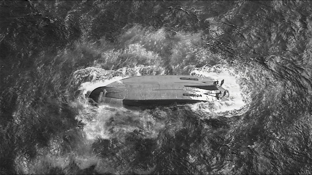 A U.S. Coast Guard HC-130 Hercules airplane crew assigned to Coast Guard Air Station Barbers Point flies over an overturned vessel offshore Saipan