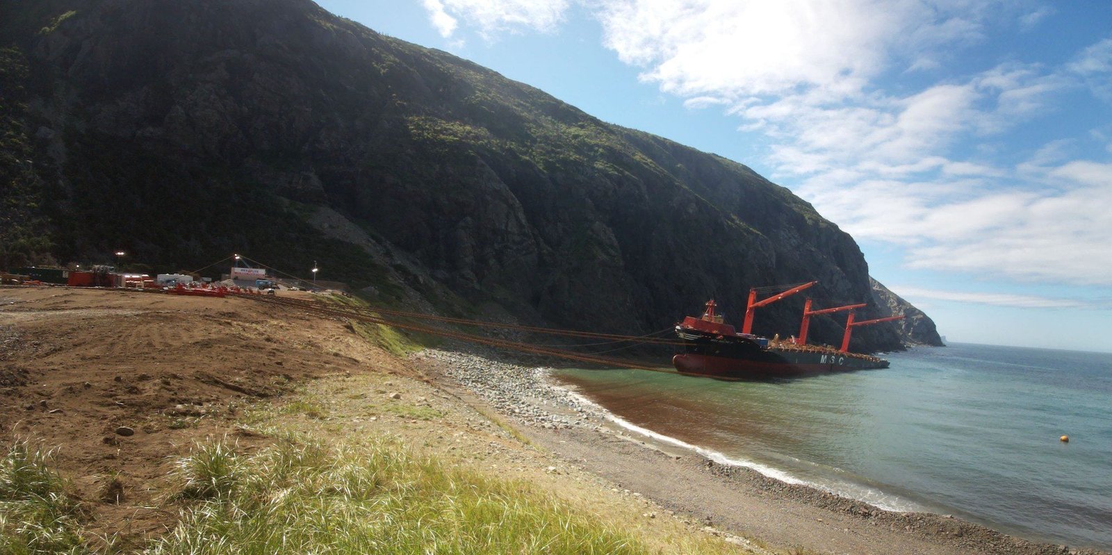 Grounded containership MSC Baltic III being pulled toward shore near Wild Cove, Newfoundland and Labrador, during wreck removal operations.