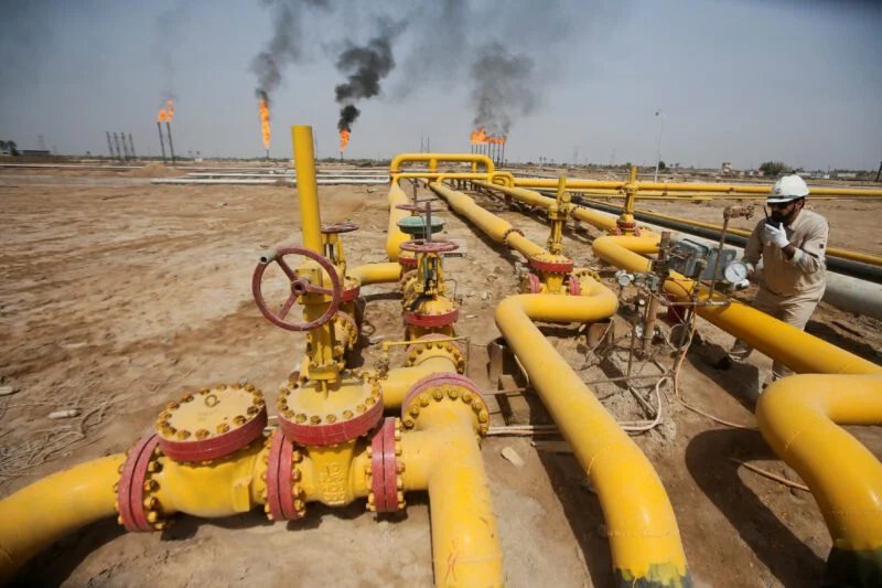 FILE PHOTO: A worker checks an oil pipeline at Nahr Bin Umar oil field
