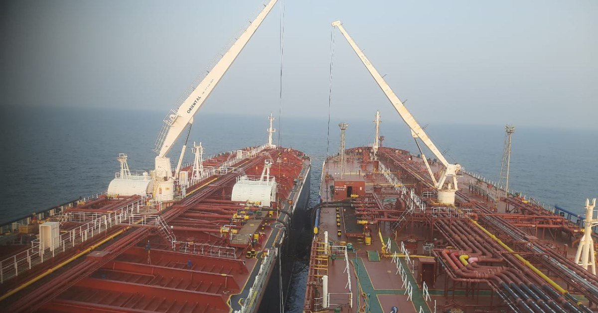 Two oil tankers moored side by side during a ship-to-ship cargo transfer at sea