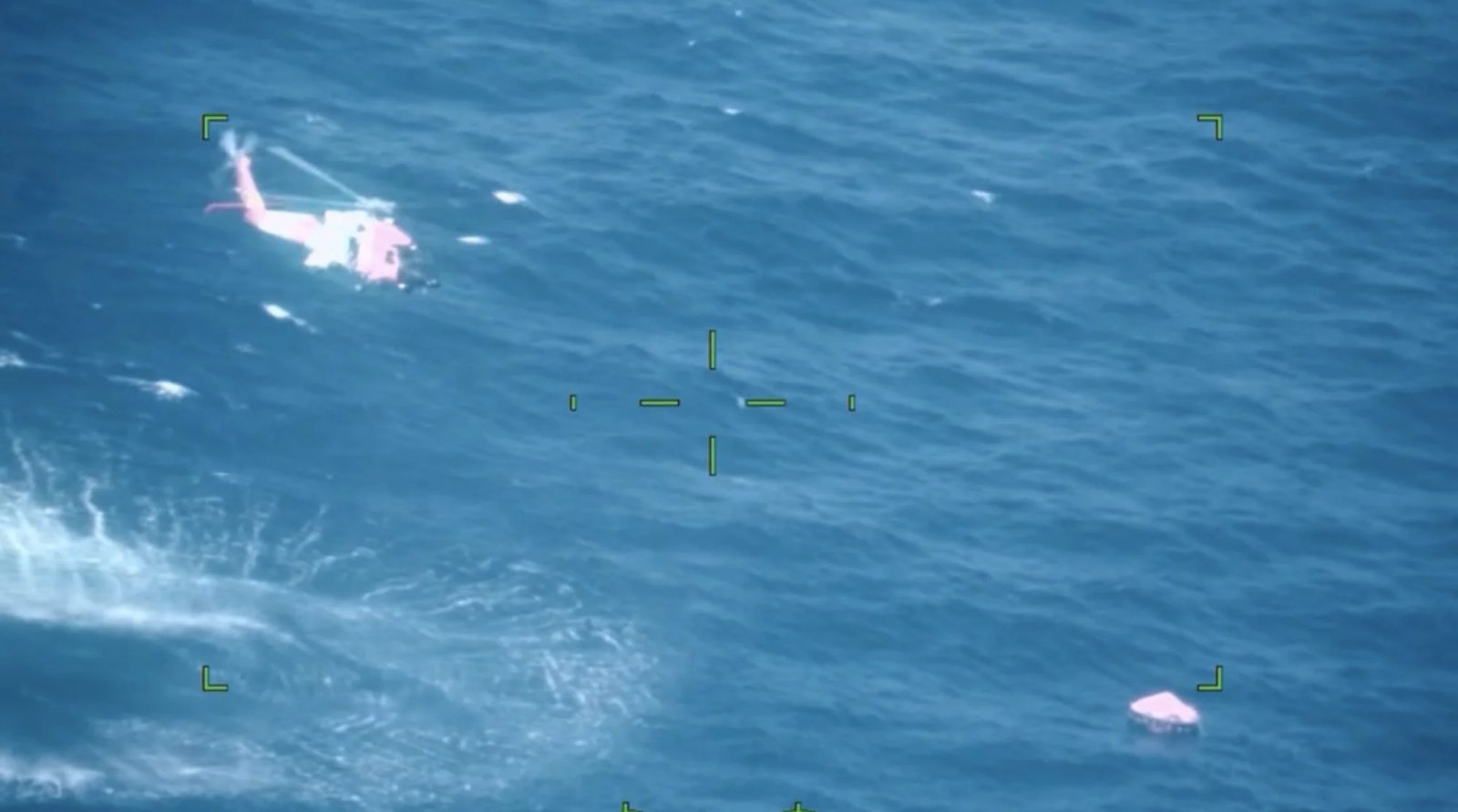 A U.S. Coast Guard Air Station New Orleans helicopter aircrew lowers a rescue swimmer to assist mariners aboard a life raft 100 miles south of Grand Isle, Louisiana, Oct. 12, 2026