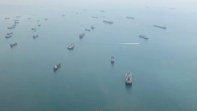 Aerial view of many cargo ships and tankers at anchor in the Singapore Strait