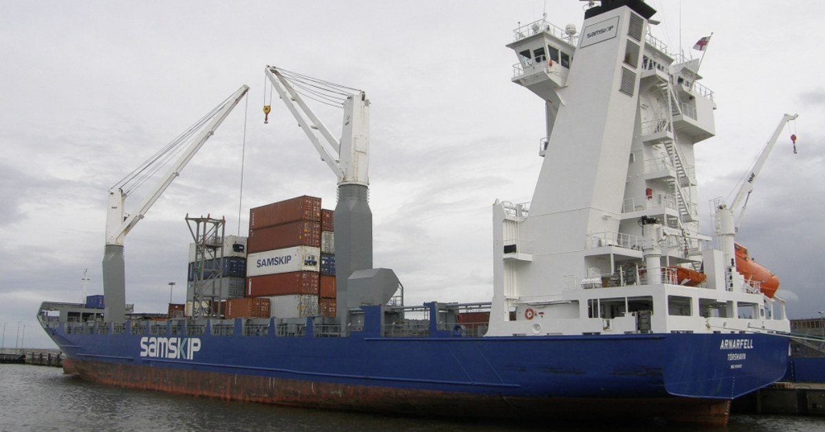 Container ship loaded with containers alongside a port quay