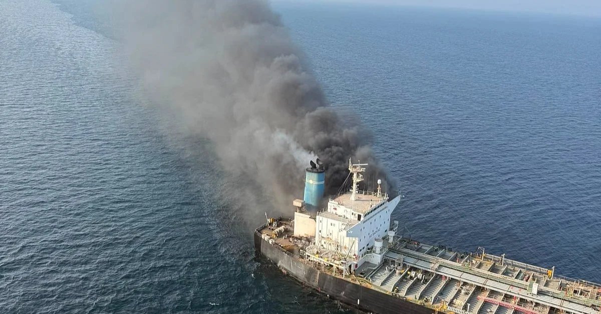 Oil tanker on fire with heavy black smoke after being hit at sea
